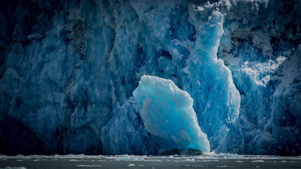 Dawes Glacier calving in Alaska aboard a small cruise ship